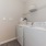 Laundry room with washer/dryer units in apartment homes at Heron Lake